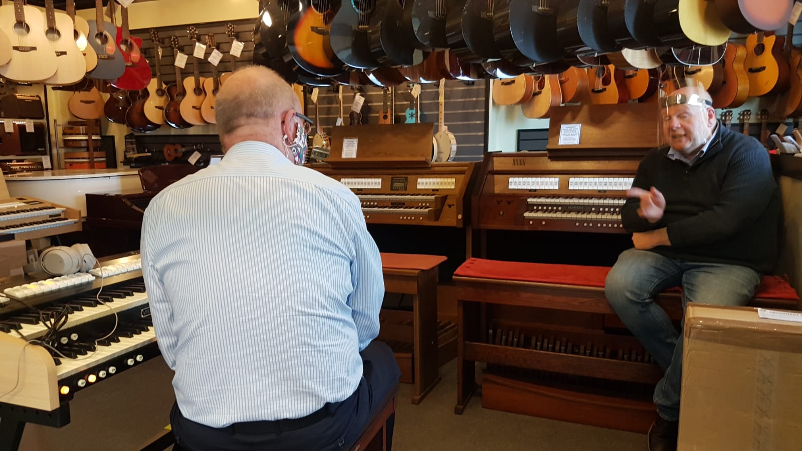 inside shop with keyboards and instruments everywhere. 